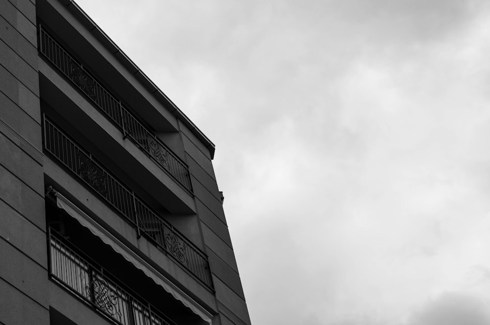 a black and white photo of a clock on a building