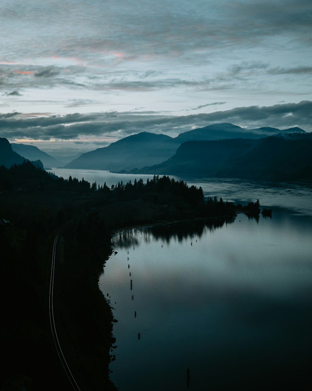 a train traveling along a train track next to a lake