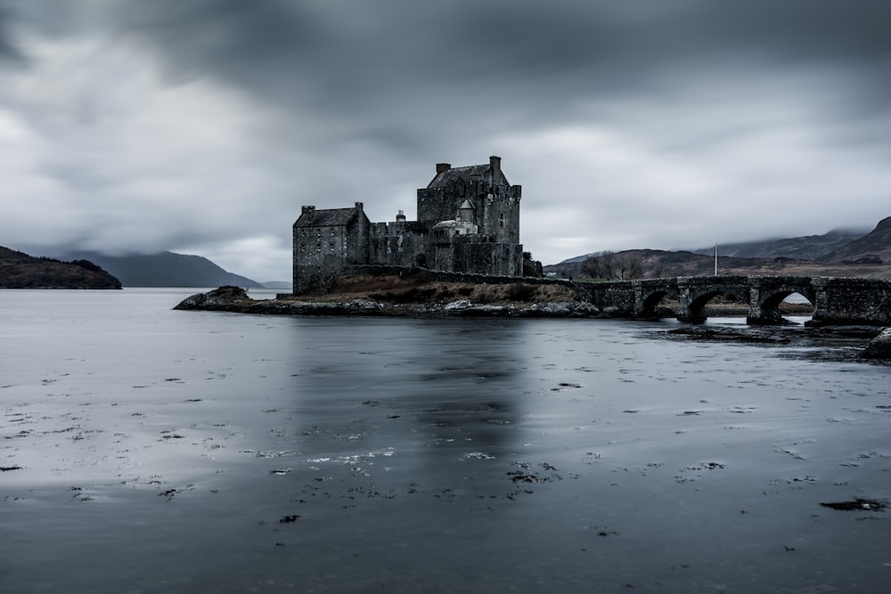 a castle surrounded by a body of water with Eilean Donan in the background