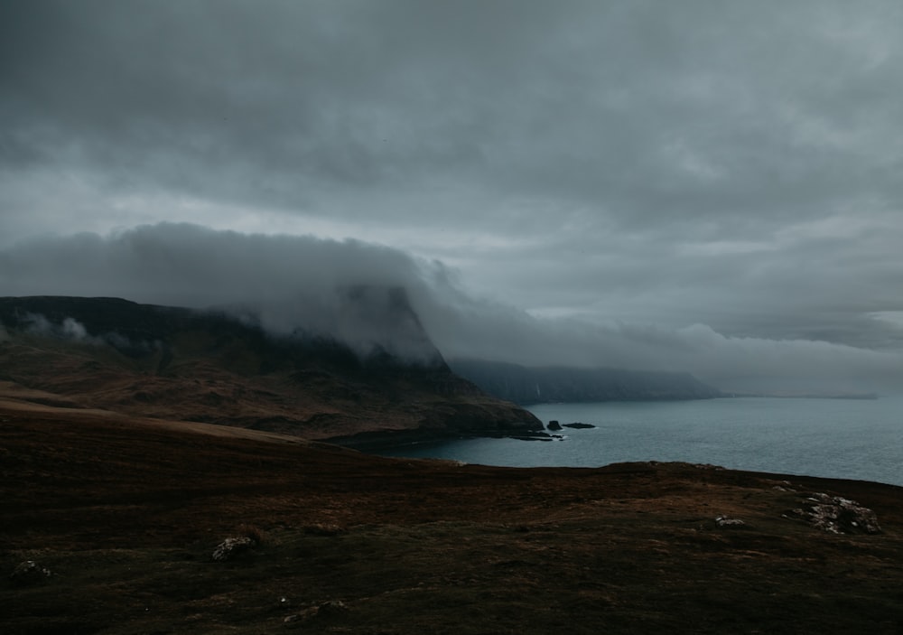 a large body of water sitting under a cloudy sky