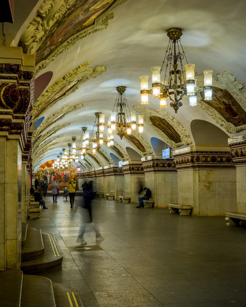 a group of people walking through a train station