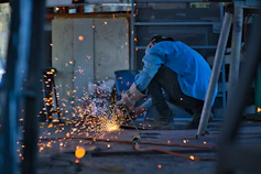 a man grinding metal with a grinder