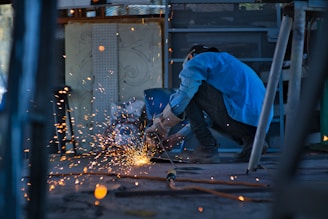 a man grinding metal with a grinder