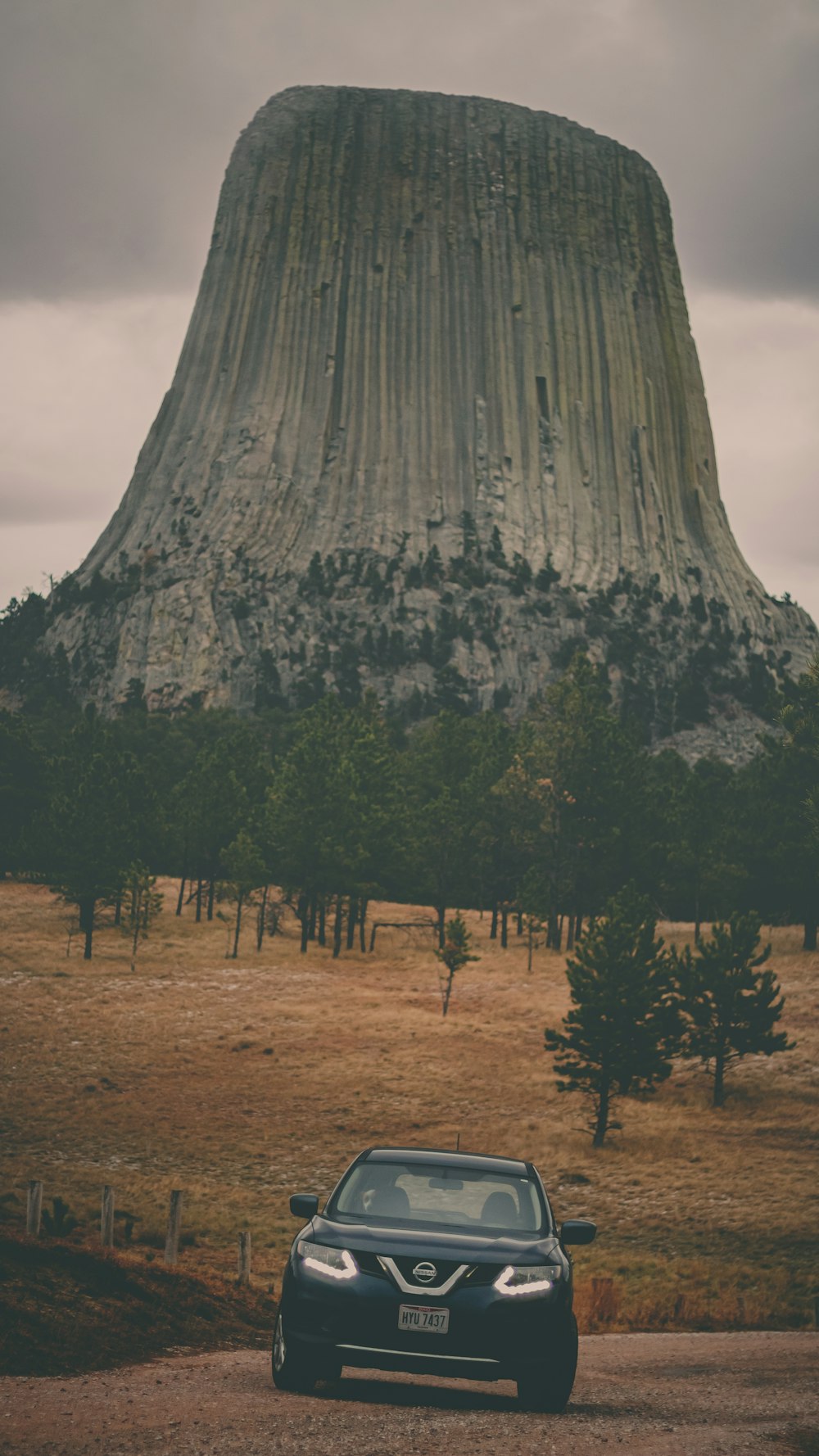 a car parked in front of a large mountain