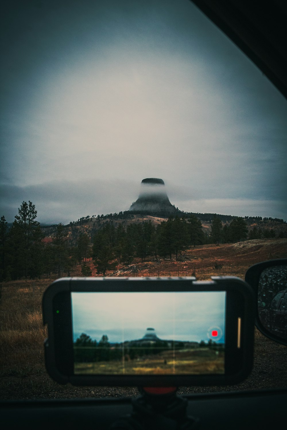 a view of a mountain from inside a car