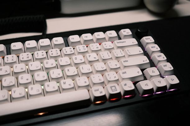 A sleek mechanical keyboard adorned with colorful otaku-style resin keycaps under soft lighting.