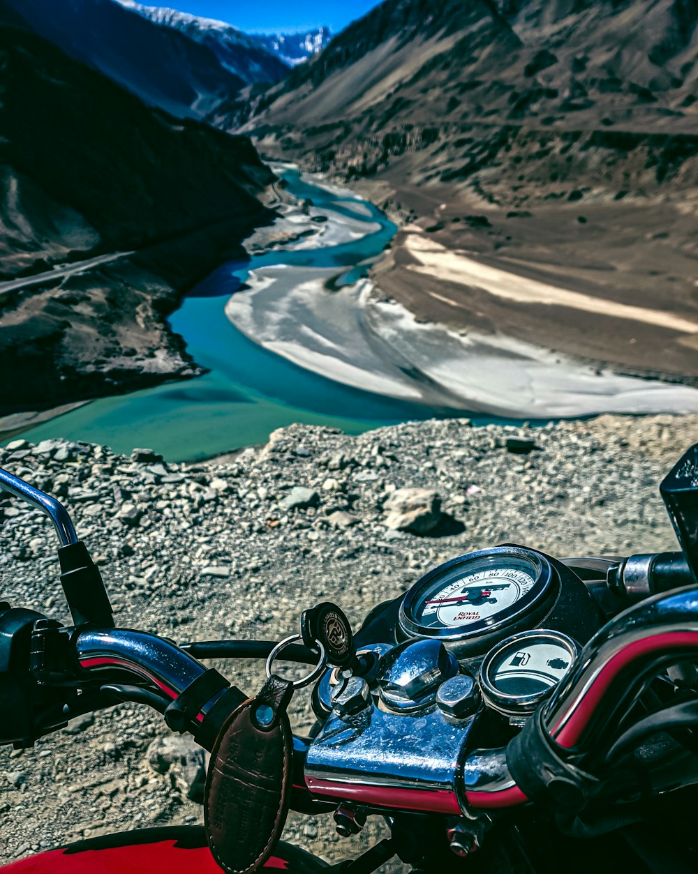 a motorcycle parked on the side of a mountain