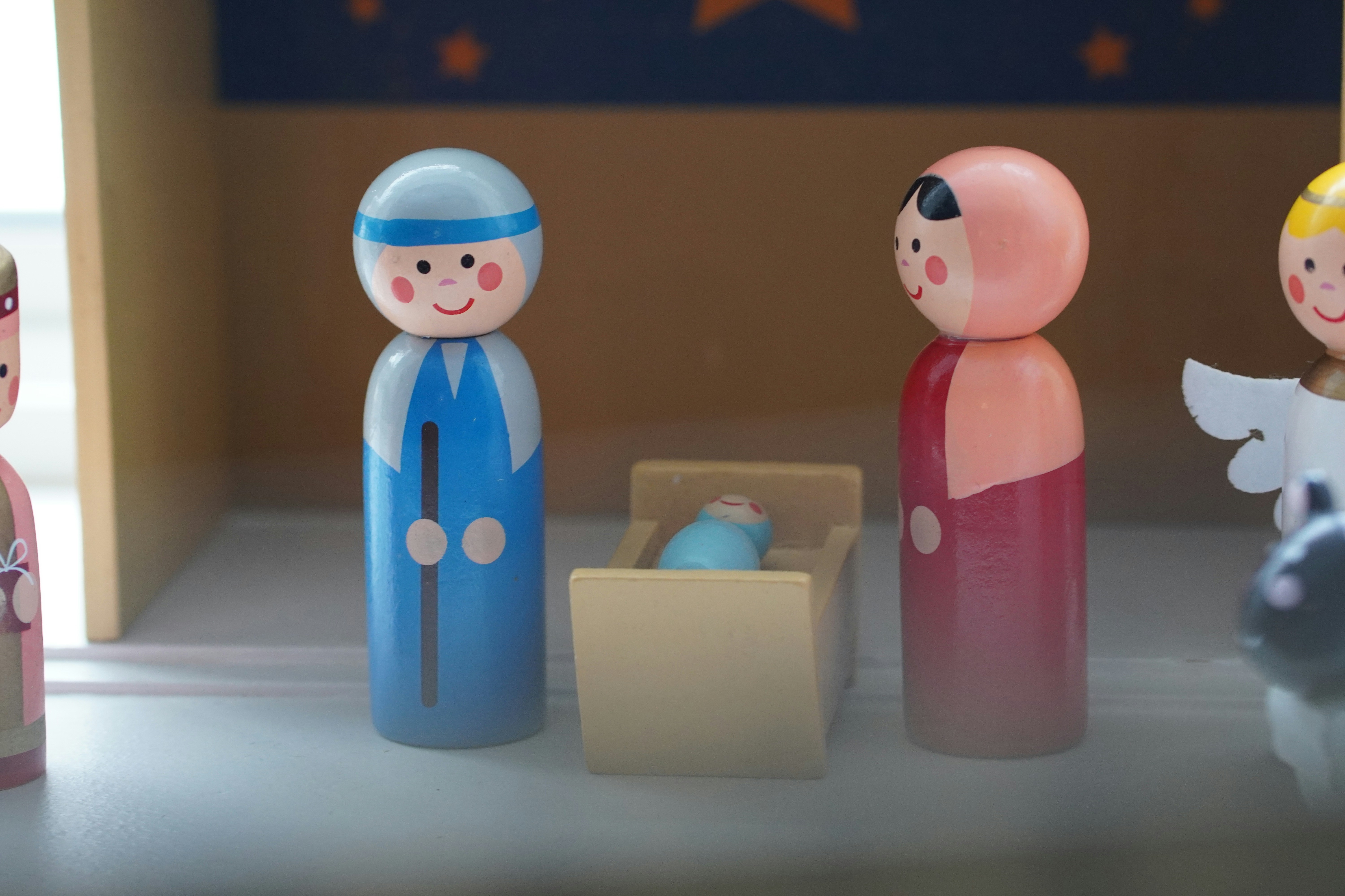 a group of wooden dolls standing next to each other