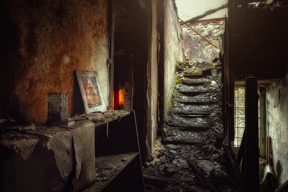 a dark room with stairs leading up to a window