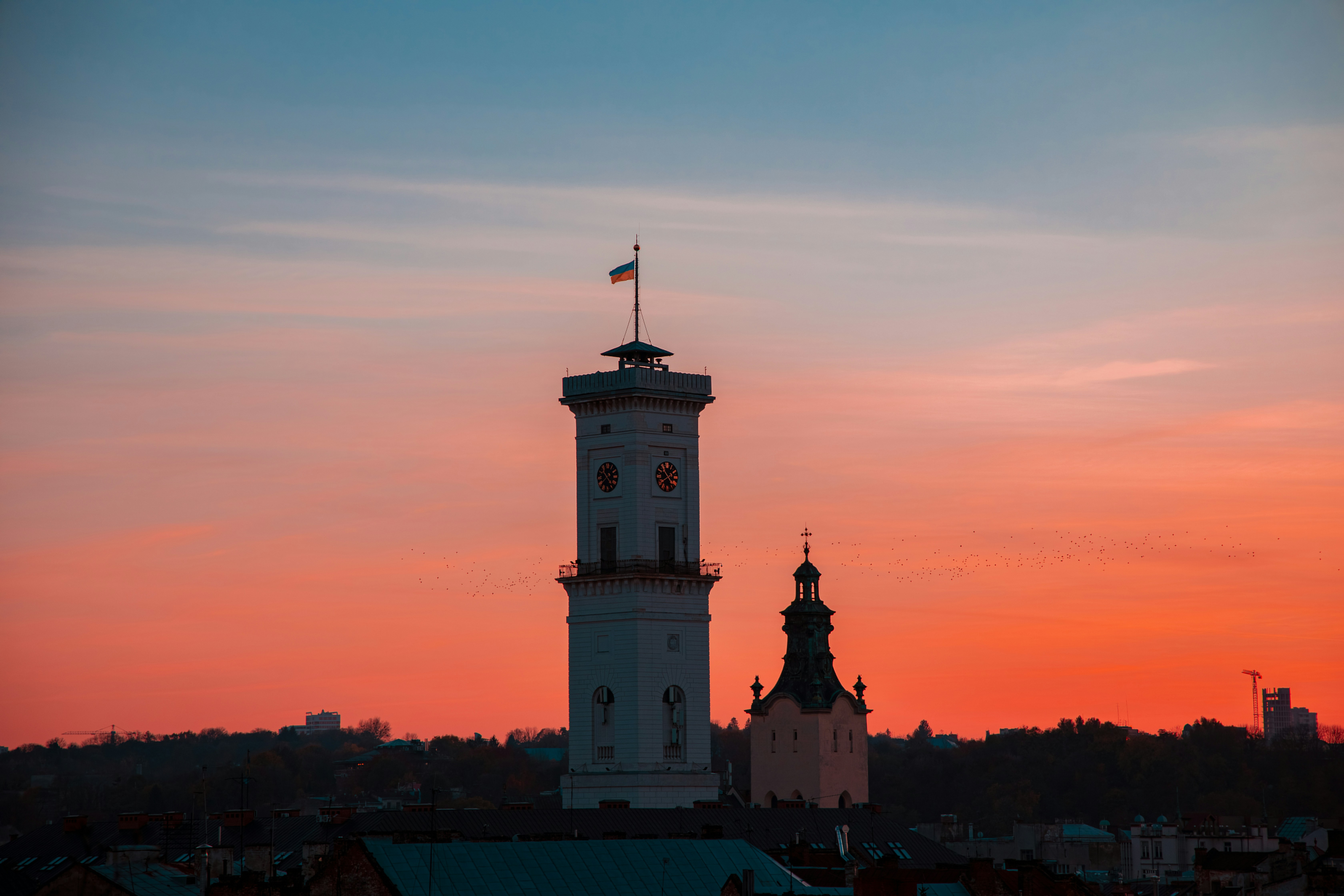 Lviv city hall tower on sunset sky background scenic view