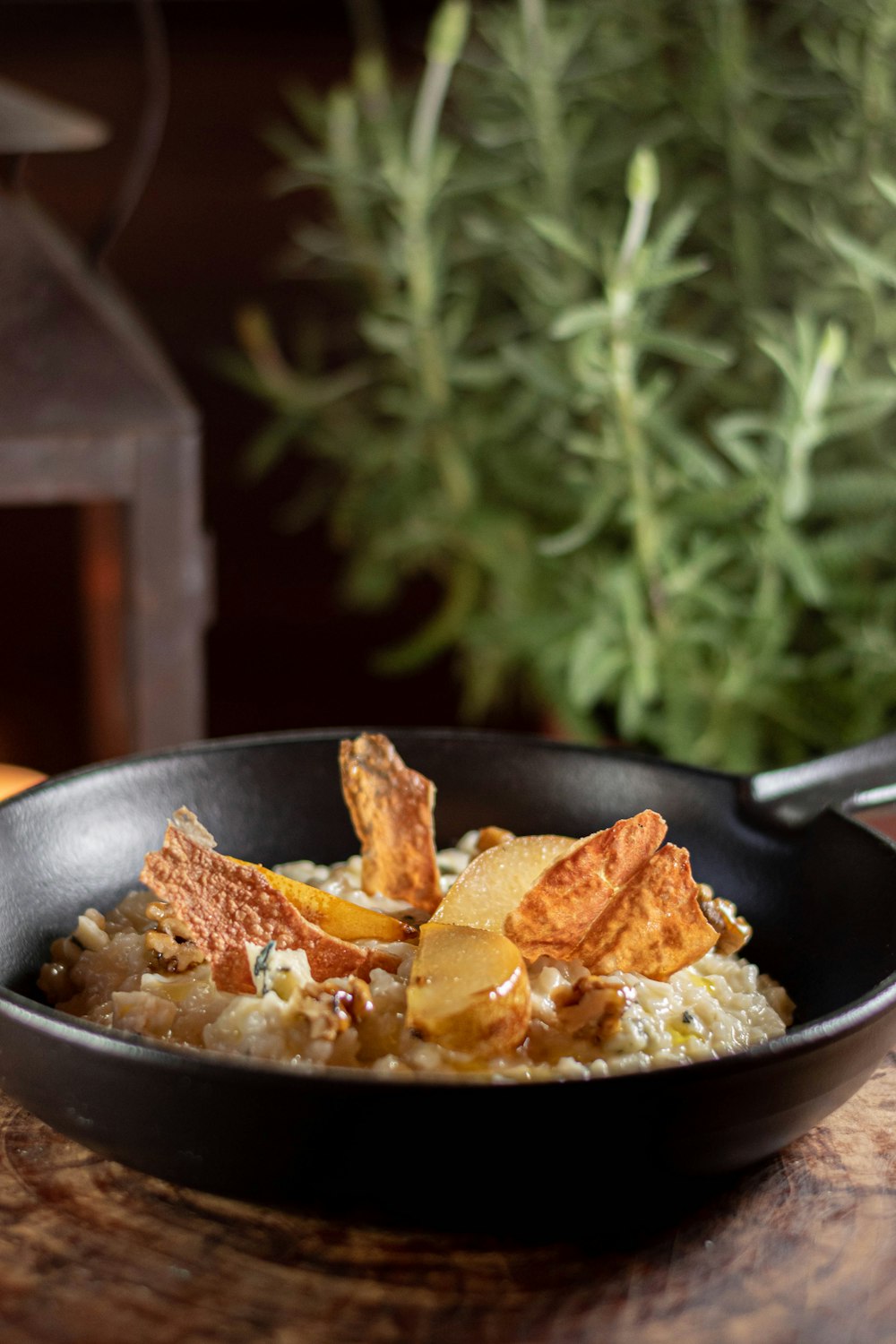 a bowl of food on a wooden table