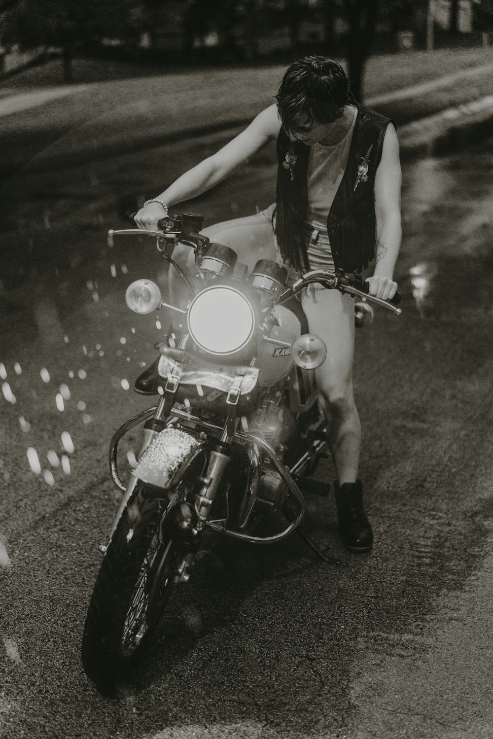 a man riding on the back of a motorcycle down a street