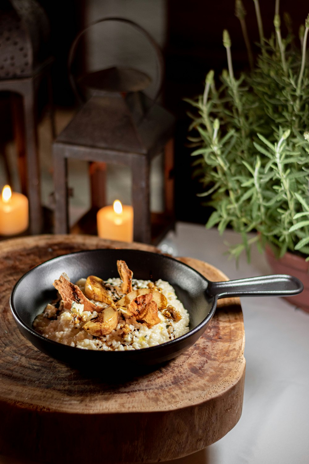 a bowl of food sitting on top of a wooden table