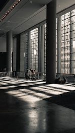 a couple of people sitting on a bench in a building