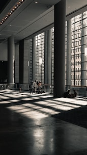a couple of people sitting on a bench in a building