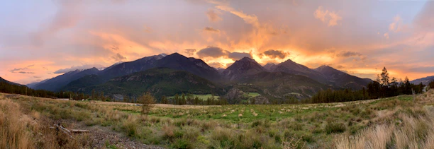 A breathtaking panoramic view of Patagonia's mountains and glaciers under a vibrant sunset.