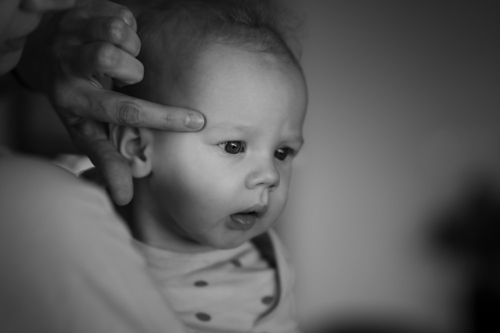 a baby is being held by a woman