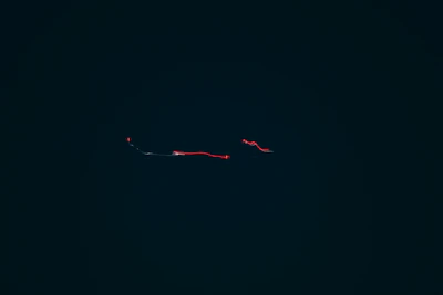 Animated cursor trail with subtle particle effects glowing in phosphor cyan on a charcoal background.