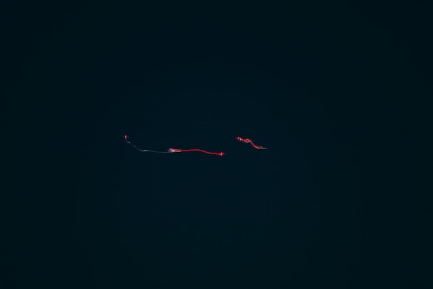 Abstract data streams flowing through a minimalistic dark interface with glowing edges.