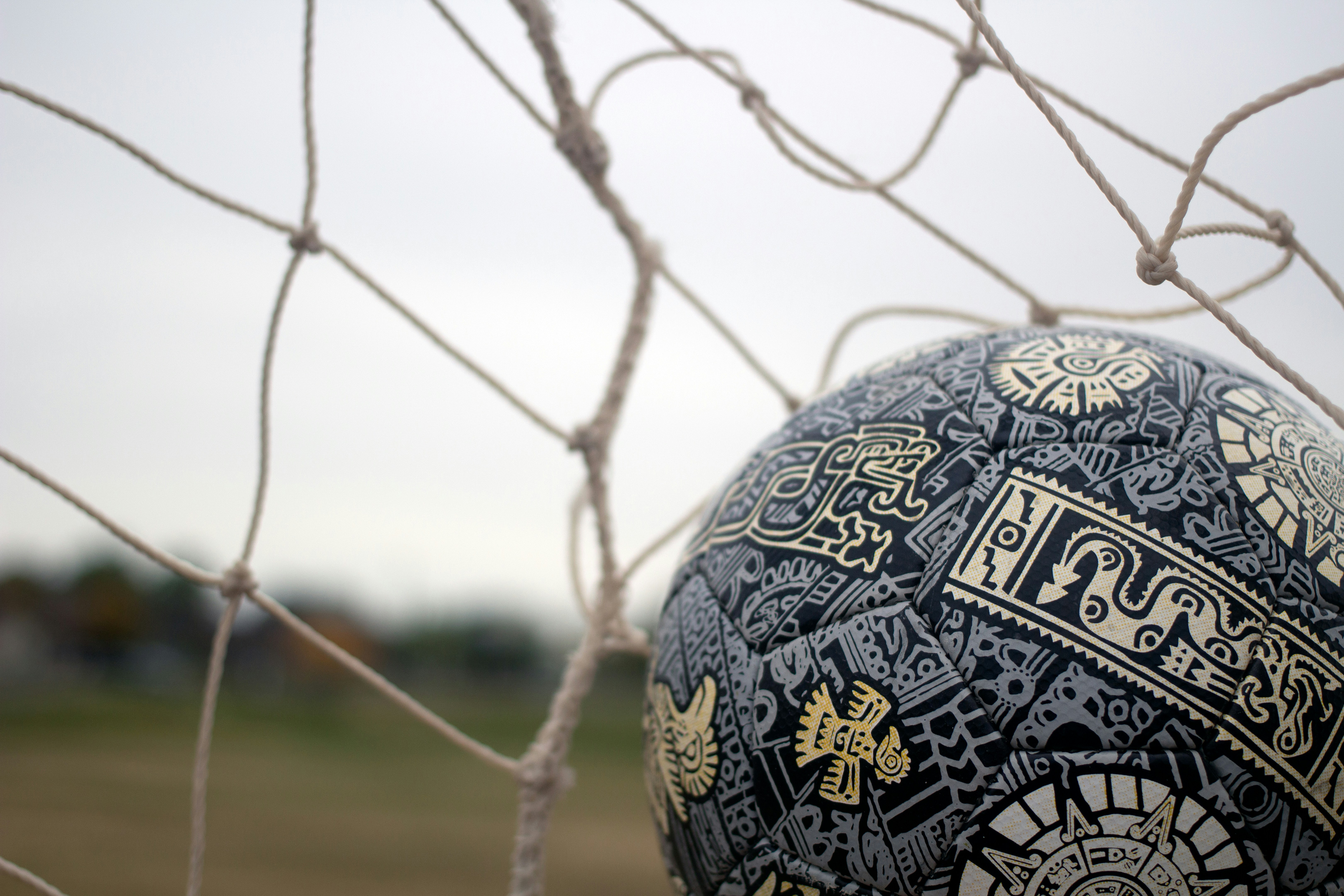 a close up of a soccer ball in a net