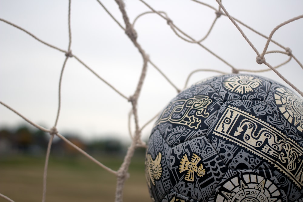 a close up of a soccer ball in a net