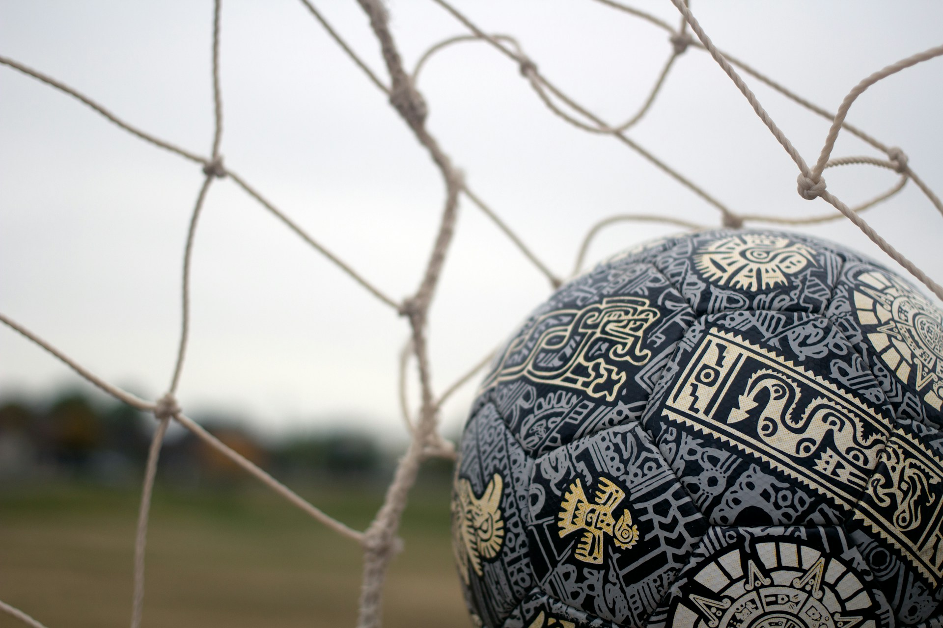a close up of a soccer ball in a net
