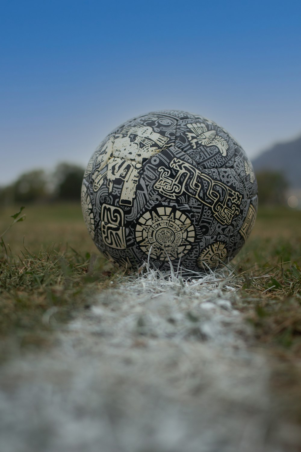 a ball sitting on top of a grass covered field