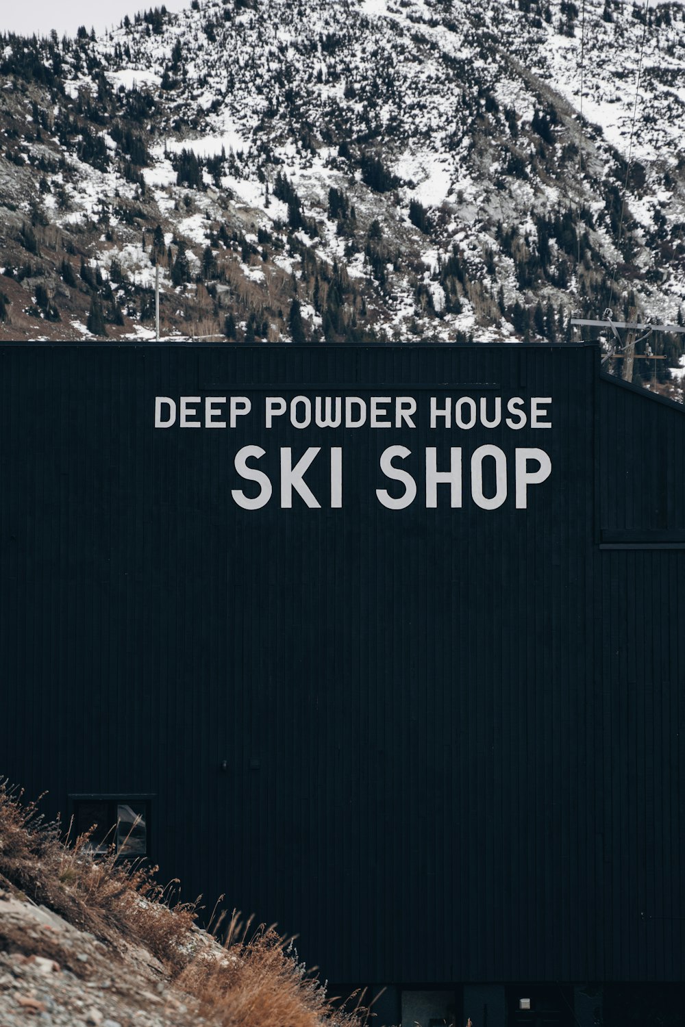 a black building with a sign that says deep powder house ski shop