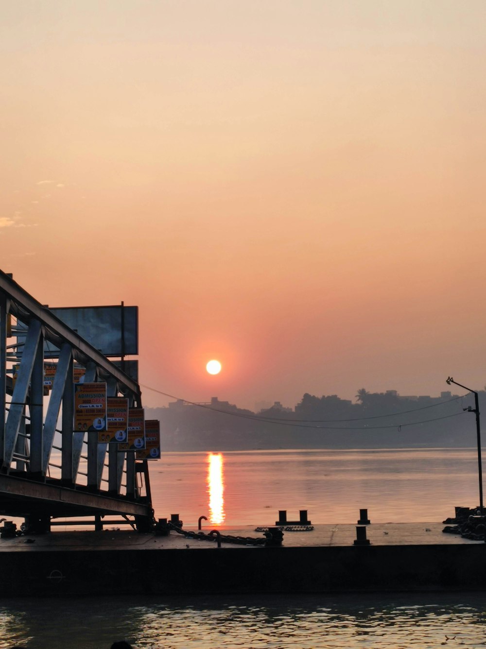 the sun is setting over a body of water