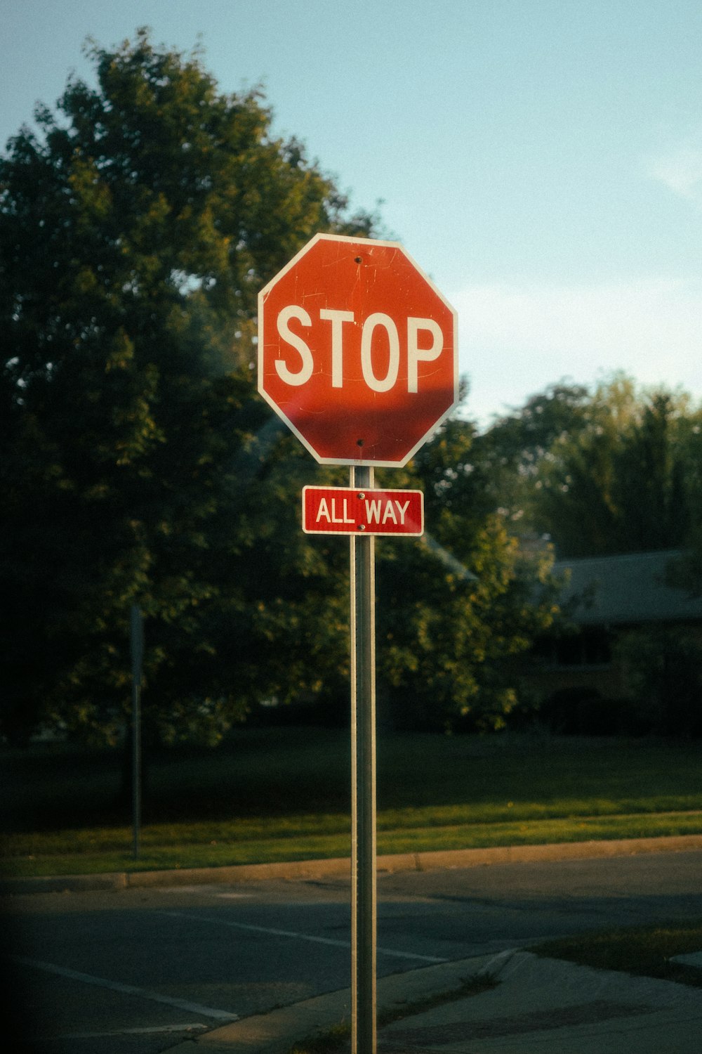 a red stop sign sitting on the side of a road