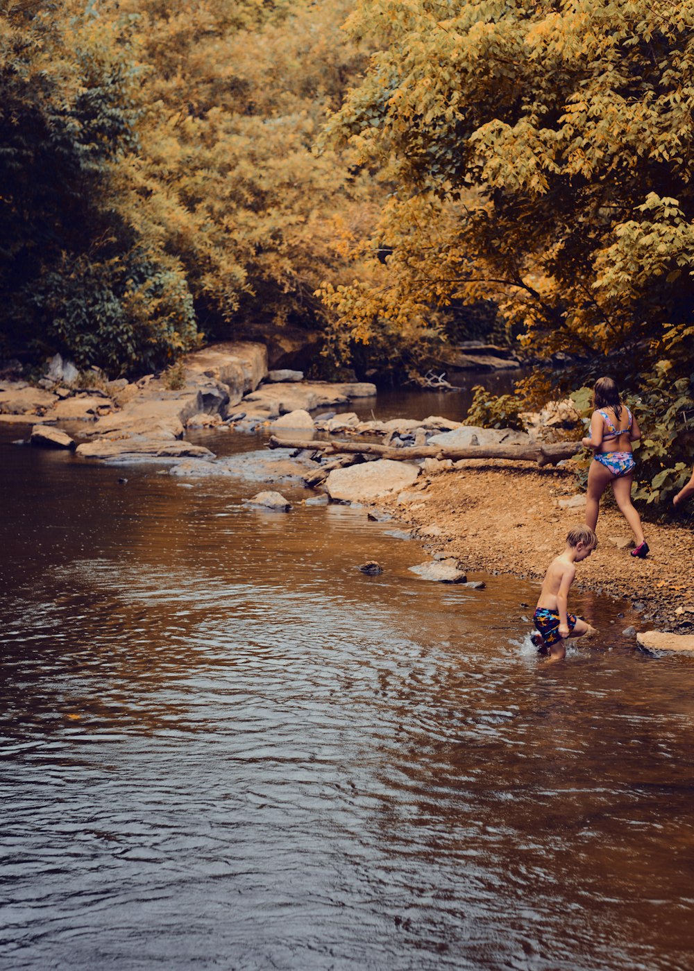 a couple of people that are standing in the water