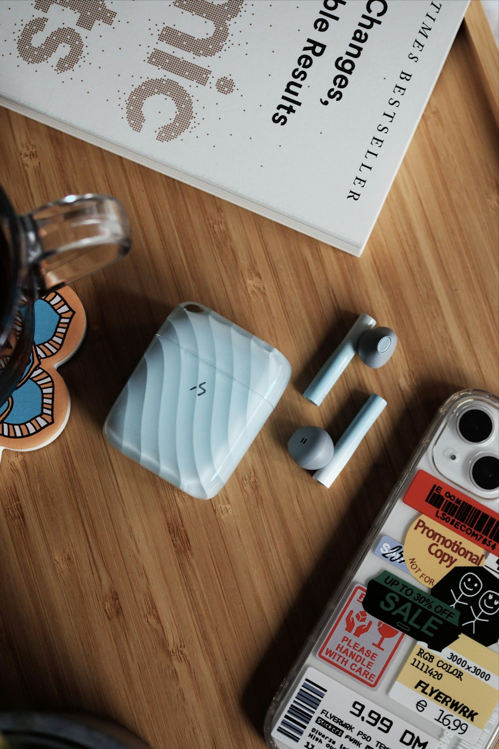 a wooden table topped with a phone and other items