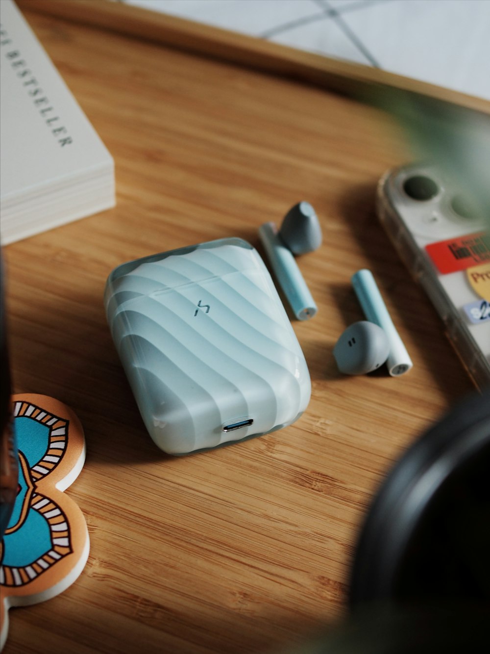 a pair of ear buds sitting on top of a wooden table