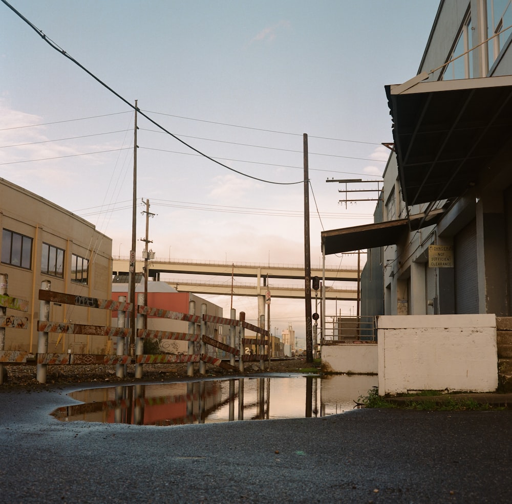 a street with a puddle of water next to a building