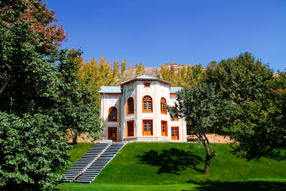 a large white house with a staircase leading up to it