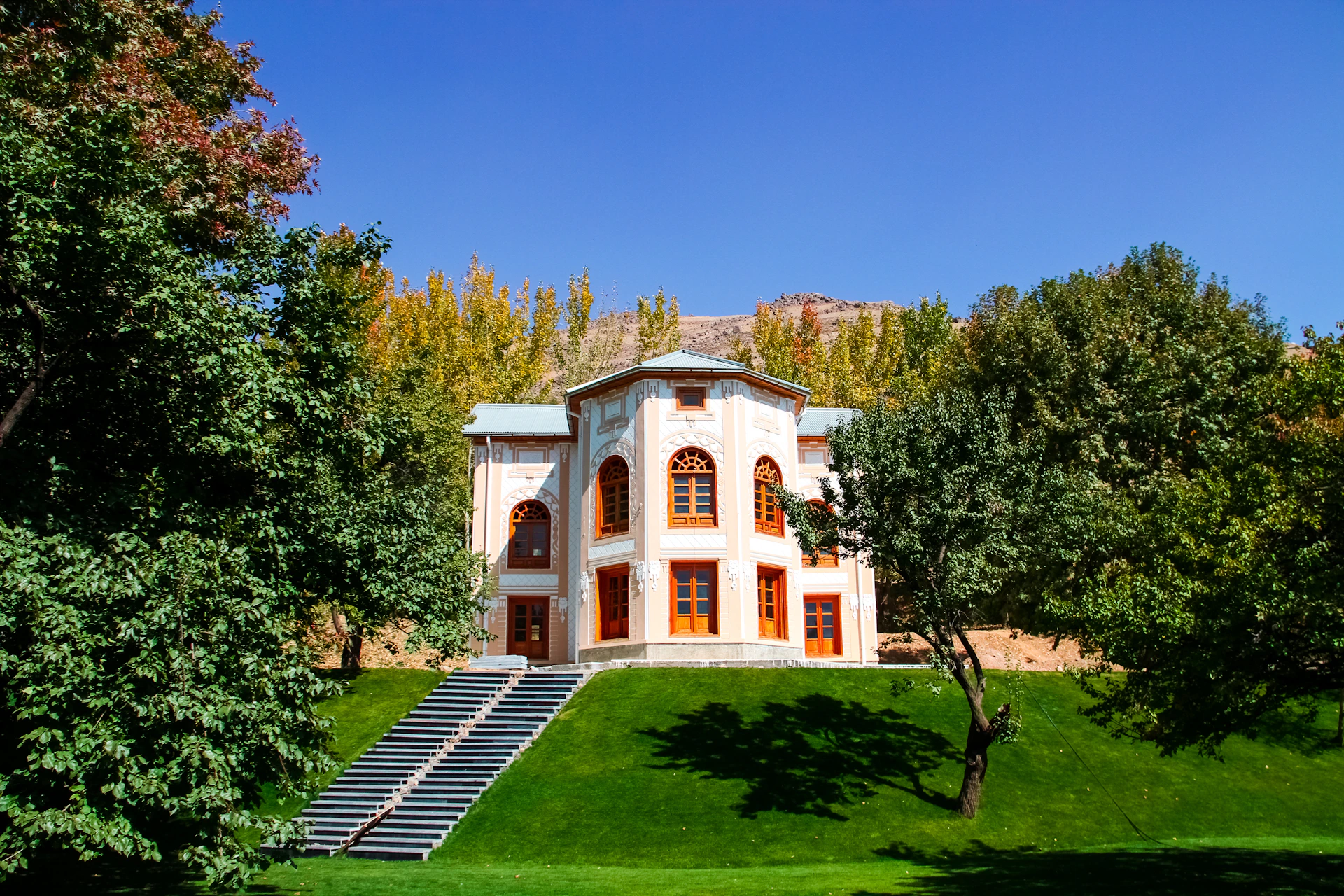 a large white house with a staircase leading up to it