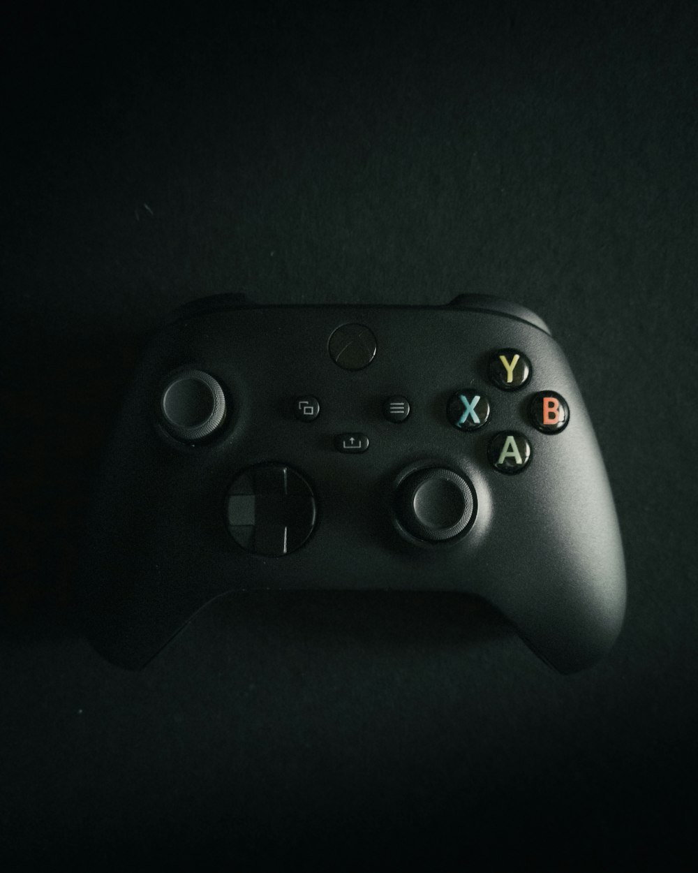 a close up of a controller on a black surface