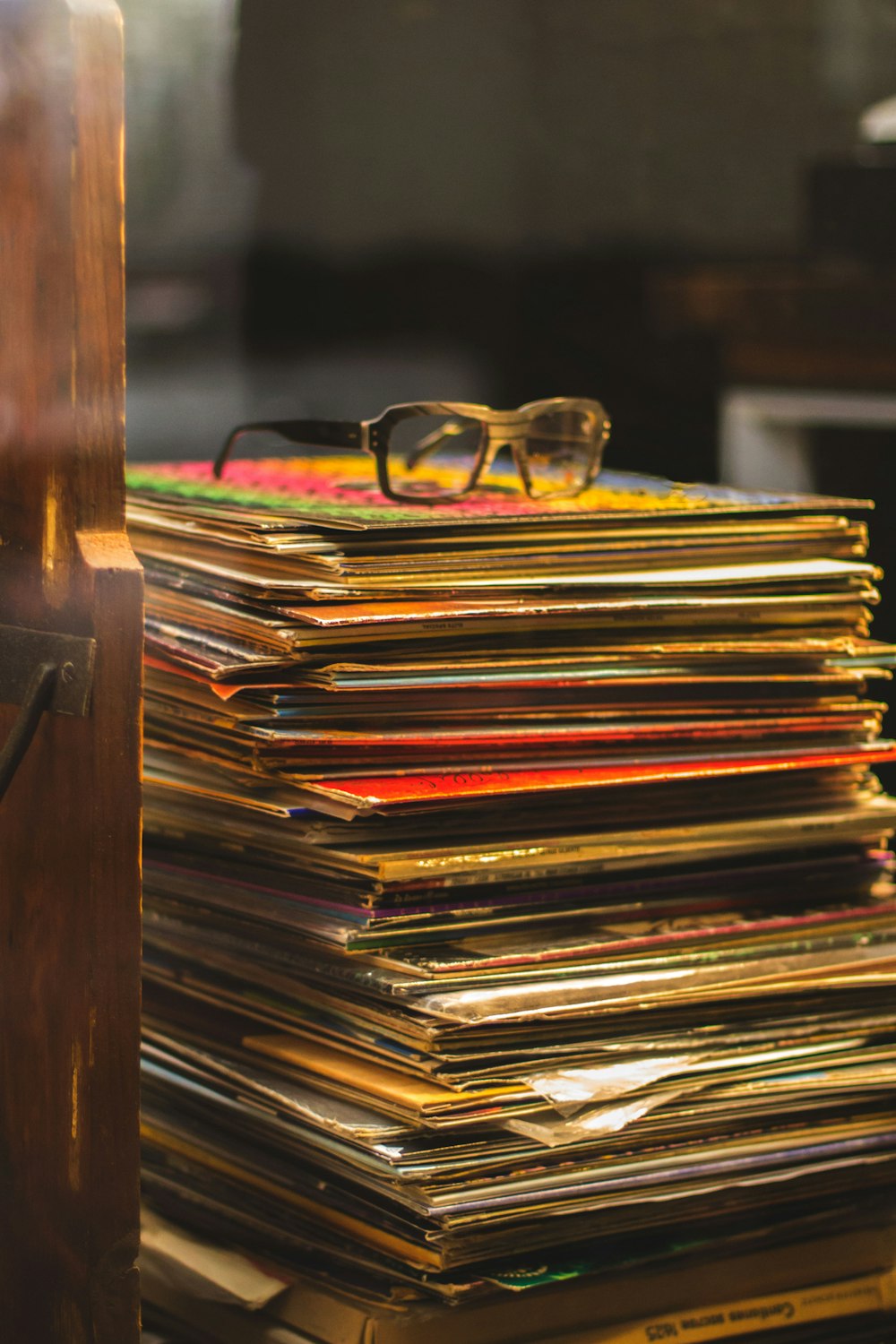 a stack of records with a pair of glasses on top