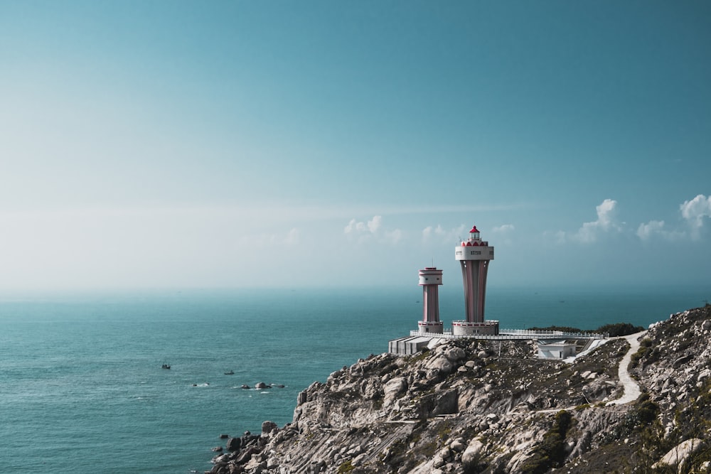 a lighthouse on a cliff overlooking the ocean