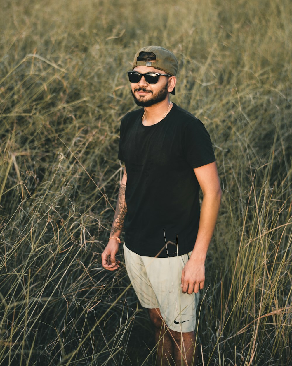 a man standing in a field of tall grass