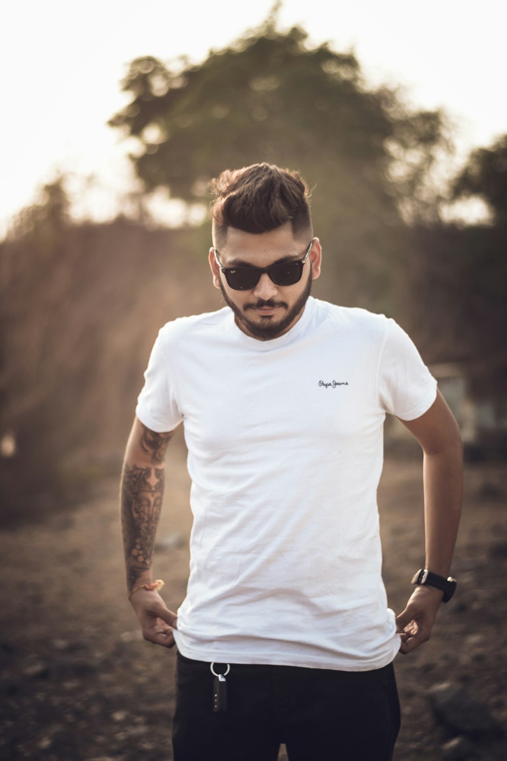 a man in a white shirt and sunglasses