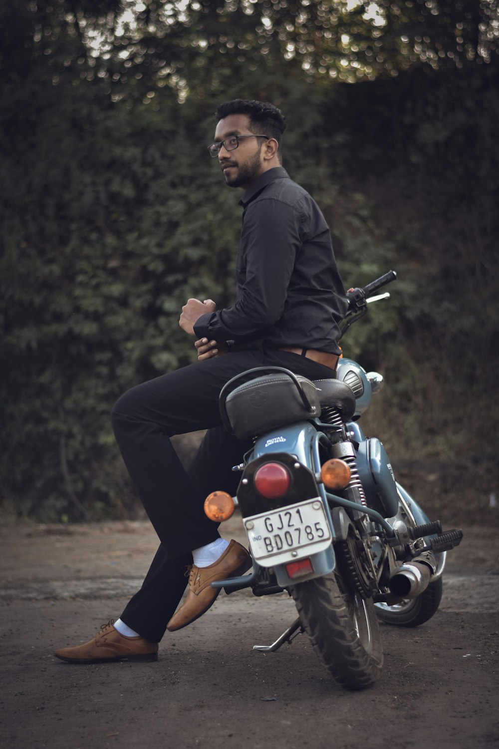 a man sitting on top of a motorcycle
