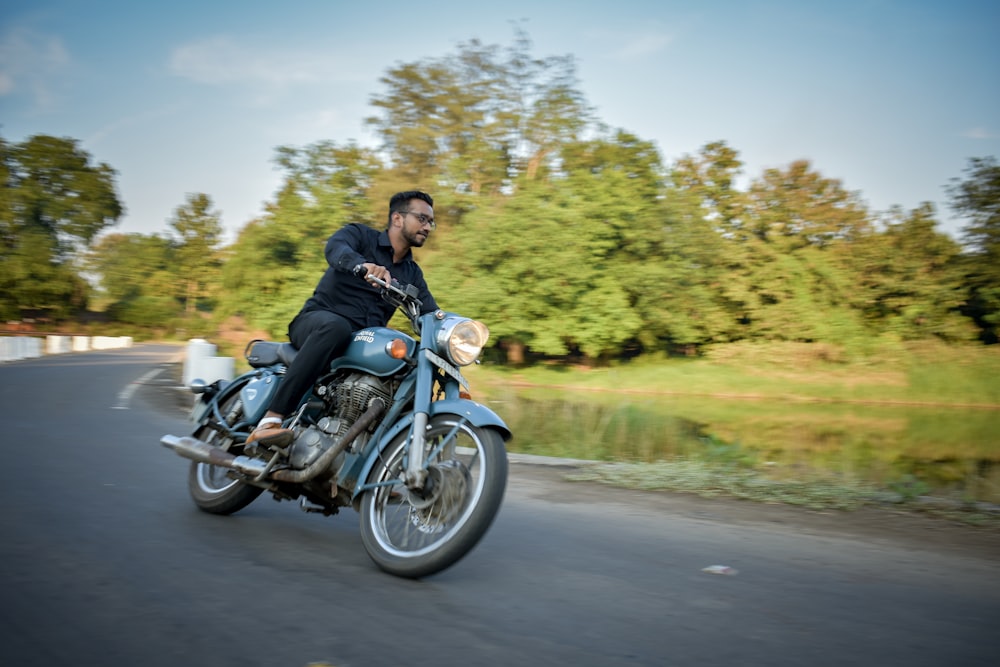 a man riding a motorcycle down a street