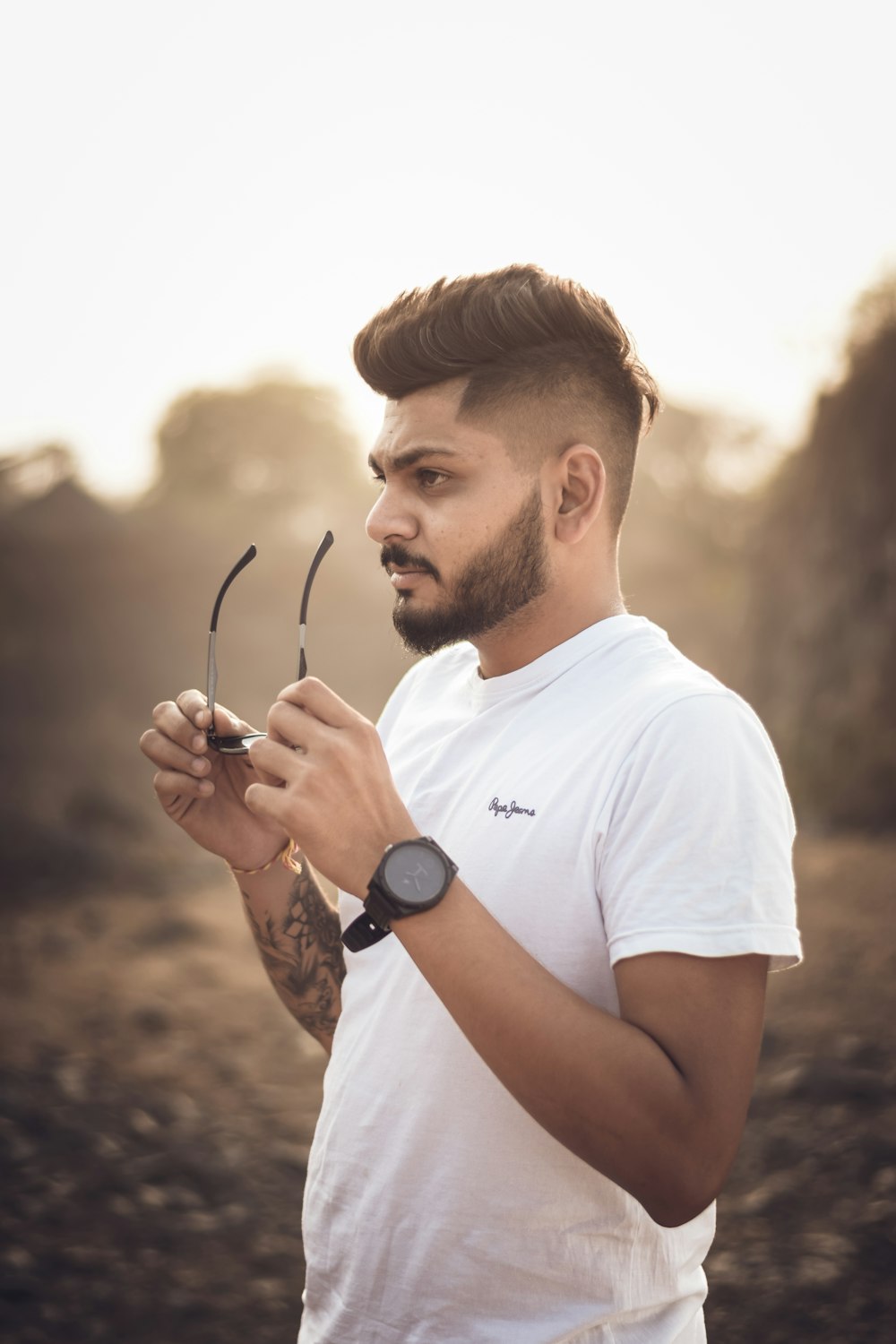 a man in a white shirt holding a pair of scissors