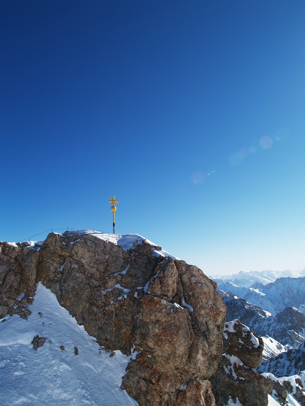 a person standing on top of a snow covered mountain