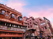 An evocative street scene in India, showing layers of culture and daily life under muted sunlight.