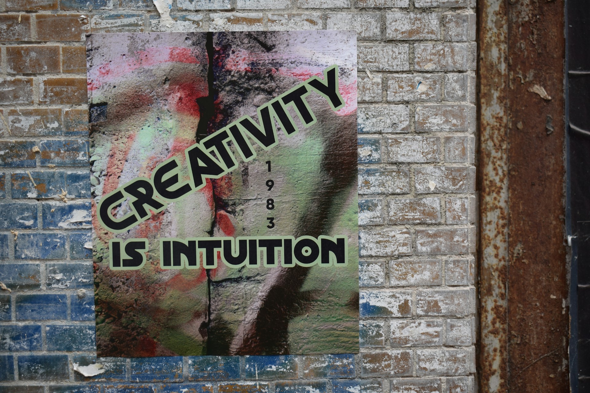 a sign on a brick wall that says creativity is institution