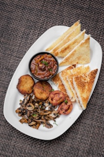 a white plate topped with sandwiches and other foods