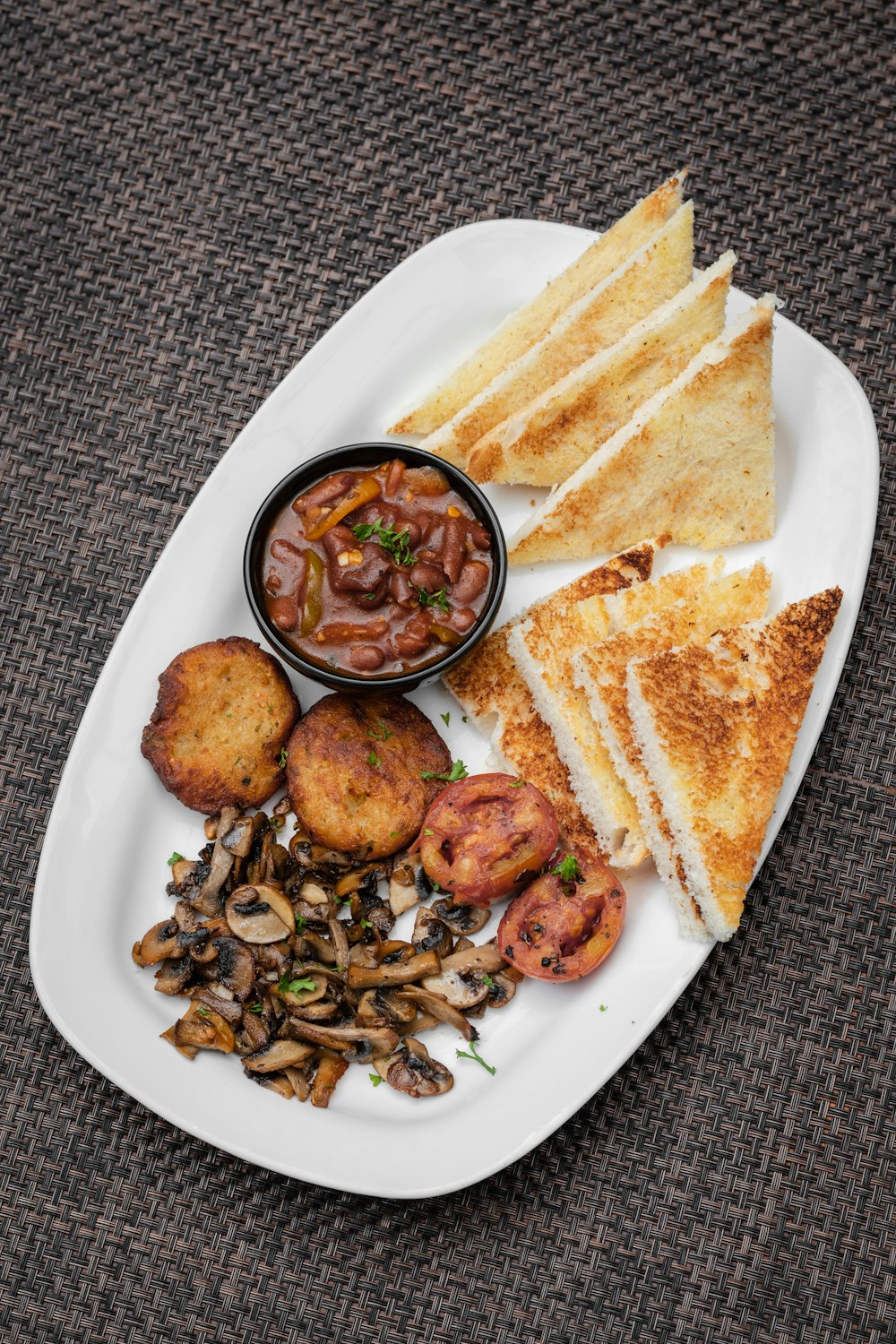 a white plate topped with sandwiches and other foods