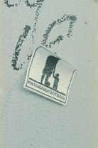 A weathered sticker is affixed to a rough-textured surface, depicting the silhouette of an adult holding hands with a child, next to a soccer ball. The words 'PASSION & FOOTBALL' are printed below the figures, suggesting a connection between family and the sport.